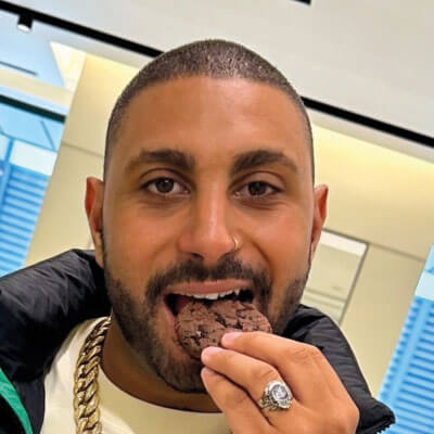 Hip middleeastern man eating a cookie